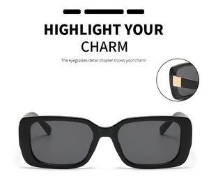 Detail view of black rectangular sunglasses with golden metal hinge decorations
