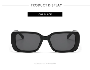 Detailed close-up of classic black rectangular sunglasses in polished finish