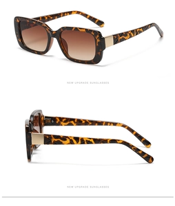Detail view of tortoiseshell rectangle sunglasses with quilted arms and gold metal hinges