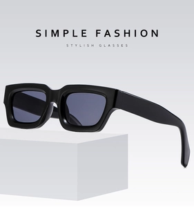 Detail of square black sunglasses with thick frames and integrated nose pads