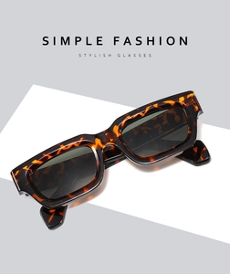 Detail view of retro tortoiseshell square sunglasses with thick frames and dark lenses