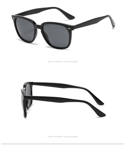 Detail view of classic black oversized square sunglasses with smooth finish and metal hinges