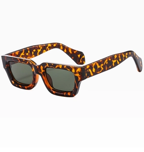 Close-up of tortoise shell pattern on thick rectangular sunglasses frame with dark lenses