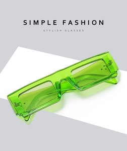 Detail of transparent green square sunglasses with integrated nose pads and metal hinges