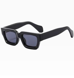 Close-up of square black sunglasses frame with polished finish and grey lenses