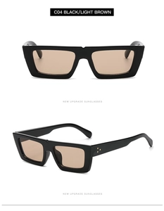 Détail de lunettes de soleil ovales noires C04 avec verres marron clair et rivets dorés