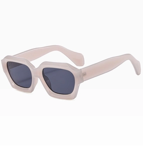 Detail view of the beige thick frame and grey lenses on these stylish square sunglasses