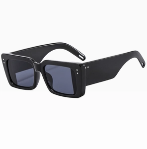 Detail shot of wide-temple square sunglasses featuring silver studs and glossy finish