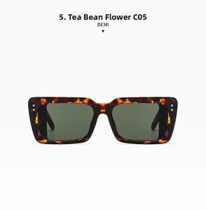 Detail view of retro tortoiseshell sunglasses with green lenses and metal rivets
