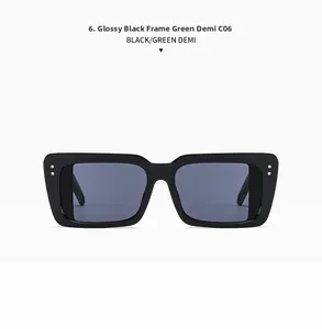 Detail view of square sunglasses featuring bright black frame and green demi temple tips