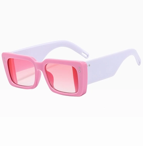 Detail view of pink rectangular sunglasses with white temples and gradient lenses