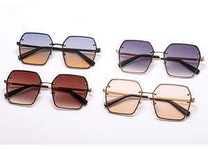 Detailed flat lay of four large square sunglasses with gradient lenses and metal rivets