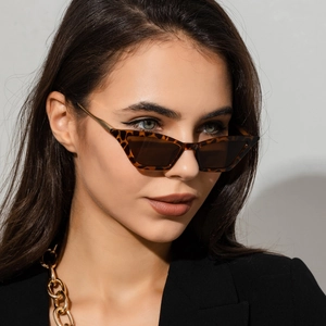 Detail of leopard print cat-eye sunglasses on model showing trendy tortoise frame