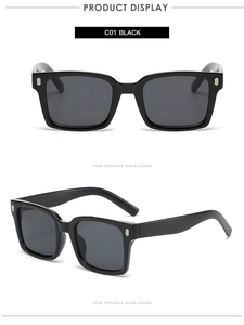 Detail view of vintage square black sunglasses with silver rivets and grey lenses