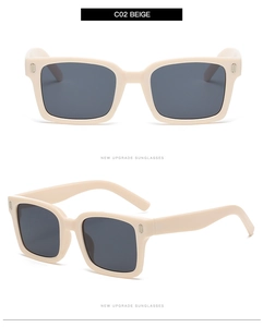 Detail view of beige square sunglasses featuring wide temples and metallic stud accents