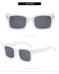 Detailed view of white square sunglasses with metal rivets and dark gray lenses