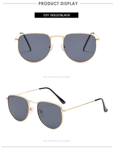 Detail view of gold metal thin frame sunglasses with dark lenses and black temple tips