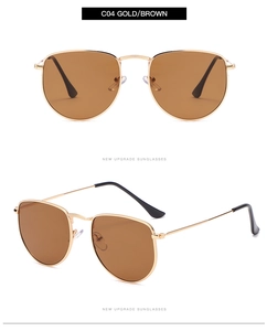 Detail of vintage aviator sunglasses featuring gold metal frame and brown lenses