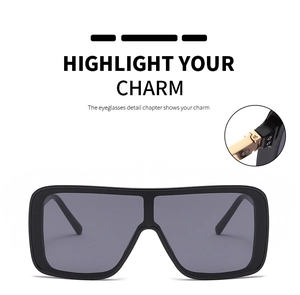 Close-up of premium gold metal hinge on oversized square flat top sunglasses