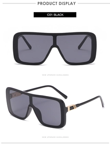 Detail view of square oversized sunglasses with gold metallic accents and flat top frame