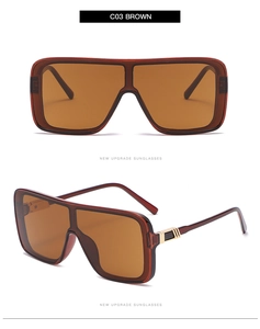 Detail view of square oversized sunglasses with brown frame and golden hinge accents