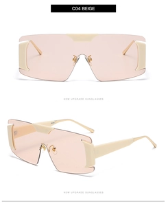 Close-up of rimless oversized sunglasses with beige frame and light orange lenses