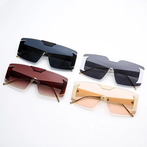 Frameless oversized sunglasses in gray, brown, and yellow lenses with golden metal temples