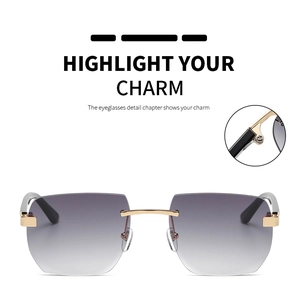 Detail of rimless square sunglasses with gradient grey lenses and gold metal hardware