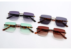 Detail view of four rimless sunglasses with gradient lenses and gold metal accents