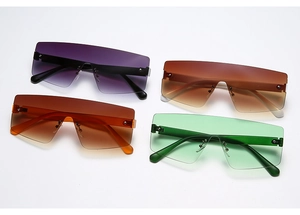 Flat lay of rimless oversized sunglasses with gradient lenses and metal rivet details