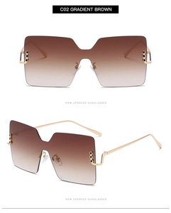 Detail view of square oversized gradient brown lenses with golden metal temples and rivets