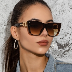 Close-up of cat-eye tortoiseshell sunglasses with interlocking gold metal temples