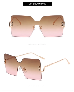Detailed view of square rimless sunglasses with brown pink gradient lenses and gold metal frame