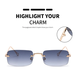 Detail of rimless rectangular sunglasses with gold metal bridge and gradient lenses