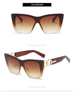 Macro detail of cat-eye sunglasses in brown with elegant golden chain temple decoration