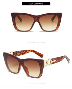 Detail view of leopard print sunglasses with golden metal chain on temples and brown lenses