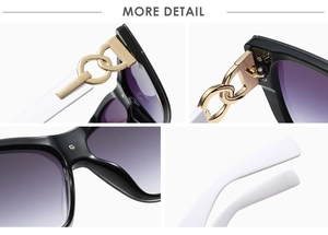 Detail of oversized sunglasses showing golden chain hinges and purple gradient lenses