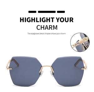 Detail of gold chain-link temple design on rimless hexagonal sunglasses for women