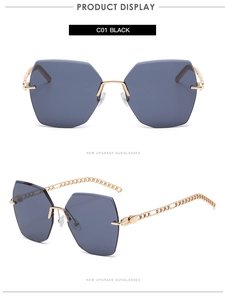 Detail of rimless polygon sunglasses with gold chain hollow temples and dark blue lenses