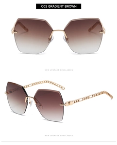 Detail of gradient brown oversized rimless sunglasses with gold cuban chain temples