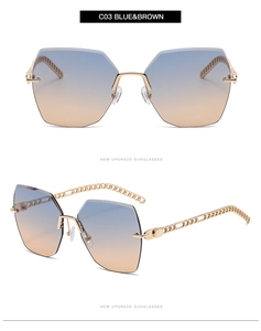 Detail of rimless hexagonal gradient lenses and golden hollowed chain temples