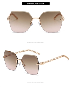 Detail of rimless polygon sunglasses with brown gradient lenses and gold chain temples