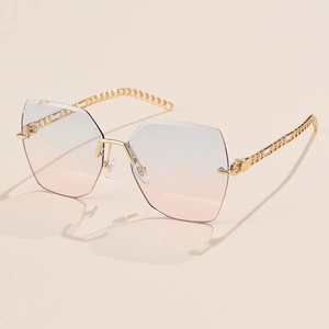Detail of rimless oversized geometric sunglasses with blue-pink gradient lenses and gold chain temples