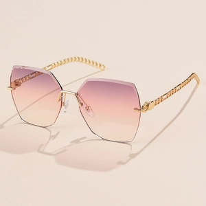Detail of gradient lenses and golden chain-link temples on oversized polygon sunglasses