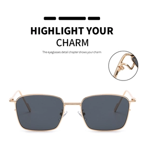 Detail view of gold metal hinge and nose pads on small square retro sunglasses