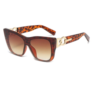 Chic tortoiseshell cat-eye sunglasses with oversized frames and gold chain detail
