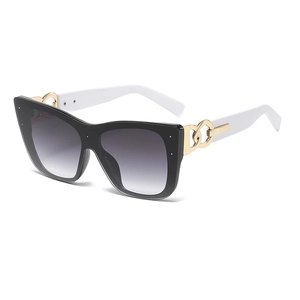 Chic cat-eye oversized sunglasses with black frame, white temples, and gold chain detail