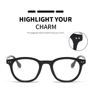 Detail view of round black frame glasses with silver double rivet hinge accents