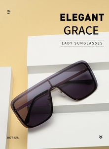 Close-up of oversized square sunglasses with purple gradient lenses on display stand
