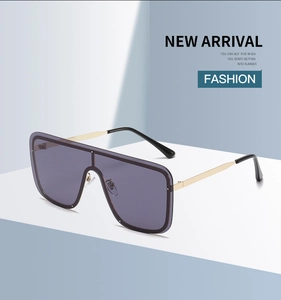 Detail view of purple lens shield sunglasses with golden metal temples and flat top frame